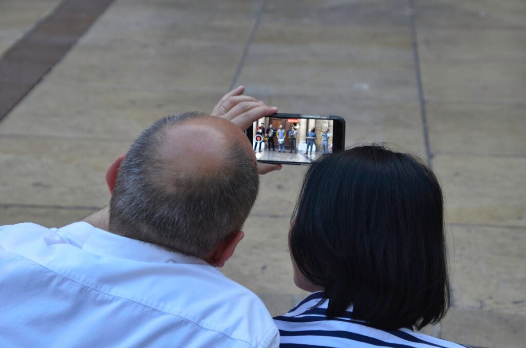 Are There Legitimate Ways To Get Paid Watching Videos Online? 1 couple watching videos, cellphone