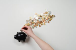 Investing Money: A Beginner's Guide to Building Wealth 1 Person investing money in a piggy bank