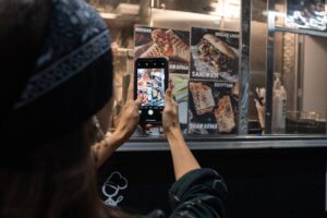 How Do I Monetize A Blog Or Website? 1 blog person taking photo using smartphone