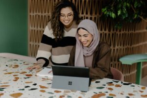 How to Start Your Own Business 1 Two business women sitting at a table with a laptop