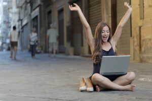 How to Get Started in Freelancing 1 Woman raising her hands happy freelancing