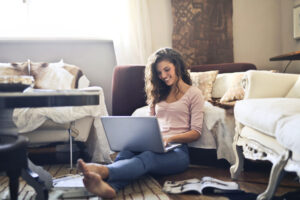 Top 10 Platforms for Freelancing 1 Woman smiling while using a platforms for freelancing